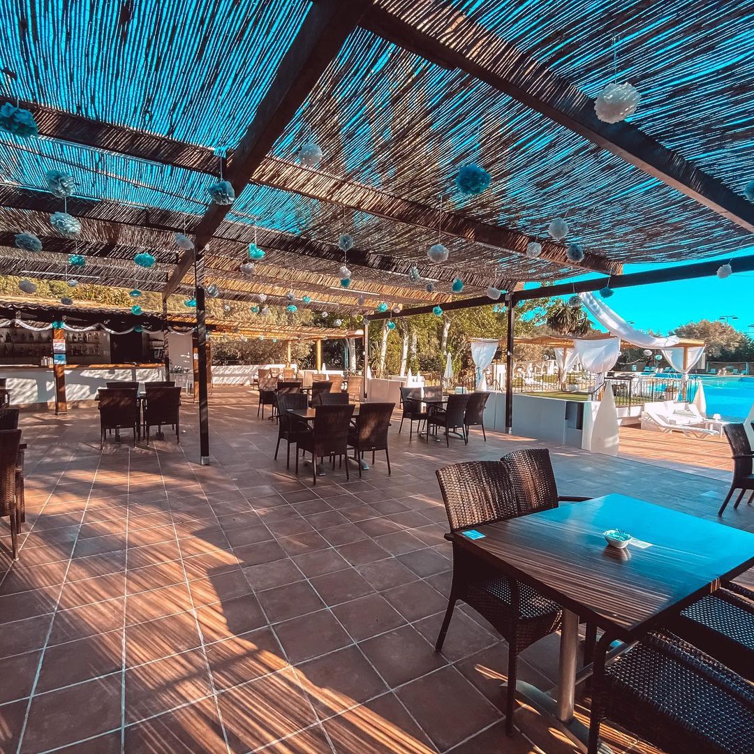 Covered outdoor dining terrace by the pool