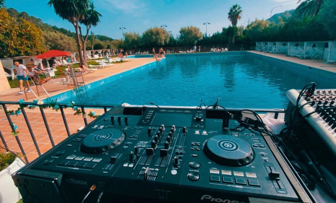 DJ playing music overlooking the pool
